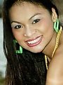 A real Thai beauty poses on the beach in a tiny bikini
